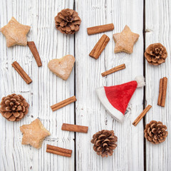Christmas pine cone decoration on white wooden board