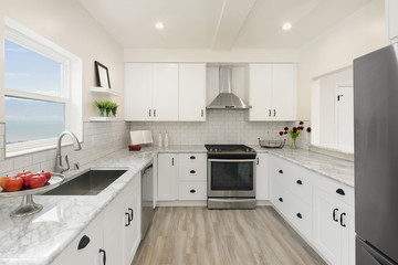 Modern, bright, clean, kitchen interior with stainless steel appliances in a luxury house