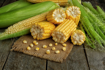 Ripe corns on wooden background