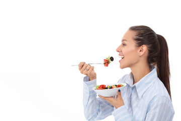 Beautiful girl eating healthy food, isolated on white background