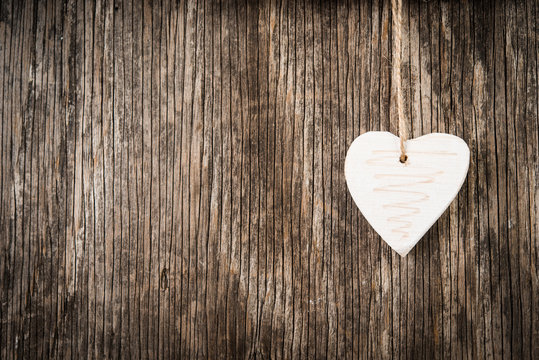 Christmas decoration in heart shape over rustic wood