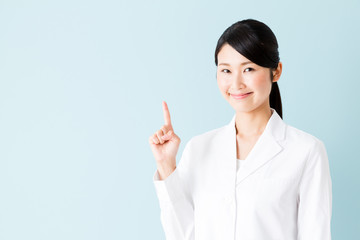 portrait of young asian nurse isolated on blue background