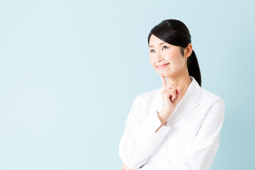 portrait of young asian nurse isolated on blue background