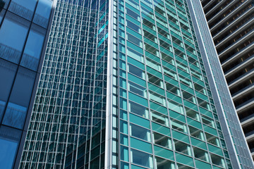 Fototapeta na wymiar Skyscrapers with glass facade. Modern buildings in Paris business district. Concepts of economics, financial, future. Copy space for text. Dynamic composition. Toned