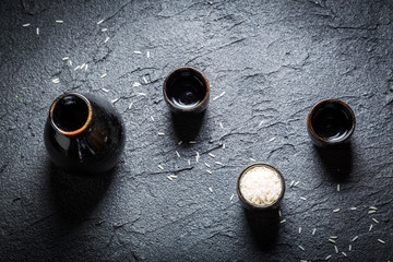 Strong sake in black ceramics on black rock © shaiith