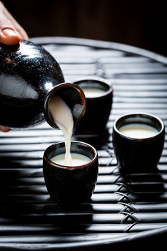 Ready to drink sake in black ceramics on black table