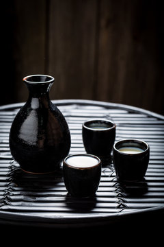 Delicious sake in black ceramics on black table