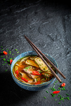 Enjoy your Red Curry soup in black bowl with chopsticks