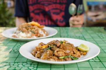 Thai street food,Fried noodle with pork on dish