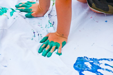 drawings made by children's hands full of colorful gouache