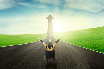 Disabled female with upward arrow on road
