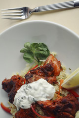 Spicy chicken meat served in a restaurant, with rice 