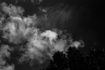 isolated clouds over black