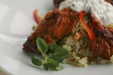 Spicy chicken meat served in a restaurant, with rice 