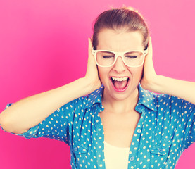 Young woman blocking her ears