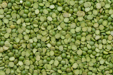 Prepared Green split peas for cooking and background