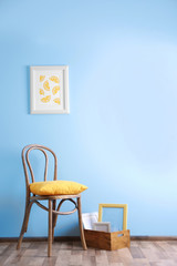 Simple interior with stool and painting on blue wall background