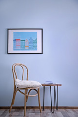 Simple interior with stool and decorations on blue wall background