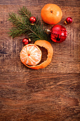 Red Christmas ornaments, food decor and fir tree branch on a rustic wooden background. Xmas card. Happy New Year. Top view with copy space