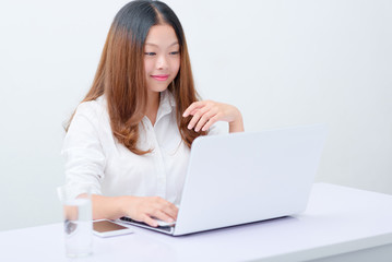 Young business woman using laptop at desk.