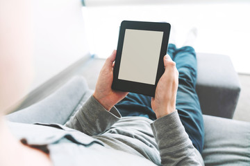 Man reading a book on e-reader