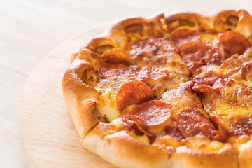 Homemade Pepperoni Pizza on wood plate
