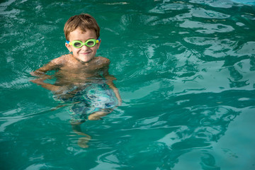 Pretty little boyl in swimming pool