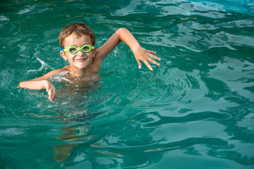 Pretty little boyl in swimming pool
