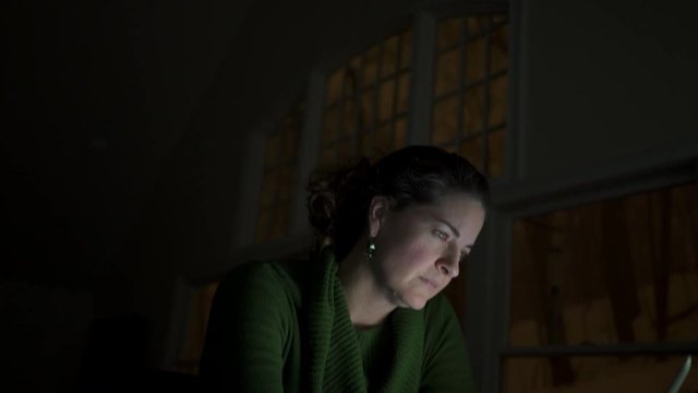 a woman watching a computer screen