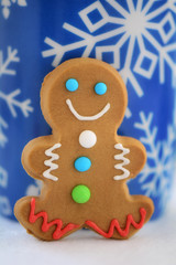 Gingerbread man with snowflake blue mug background