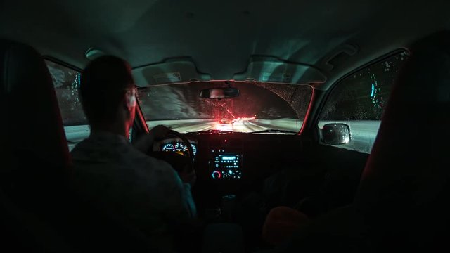 Time-Lapse of Man Driving on Snowy Mountain Road from Inside Car