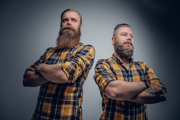 Two brutal bearded men dressed in a plaid shirt.