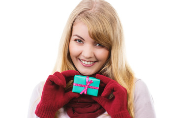 Woman holding wrapped gift for Christmas or other celebration