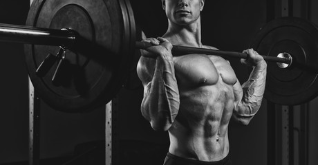 Obraz na płótnie Canvas Athlete lifting heavy weights