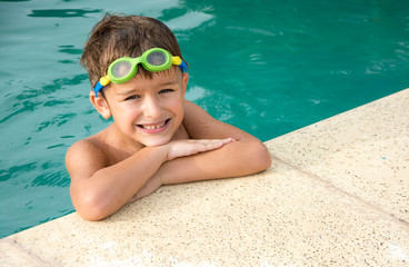 Pretty little boyl in swimming pool