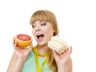 Woman choosing fruit or cake make dietary choice