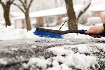 Transportation, winter  and vehicle concept - man cleaning snow