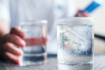 Freshness every day. Glass of very cold water in girl's hand transparent glass. Quench their thirst.
