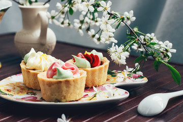 cakes on the table in the background of the cherry blossoms