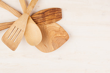 Design concept of mockup of empty wood beige spoons on white wood background.  Copy space. Top view.