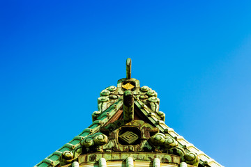 Fototapeta premium A historical temple called Taishakuten, the roof and the Japanese clear winter blue sky.