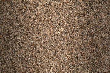Background of randomly packed small granite stone pebbles