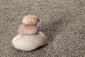 Fototapeta na wymiar stack of pebbles on balance on granite gravel