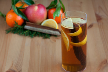 Glass with Seasonal warming drink.Cinnamon,lemon zest and some f