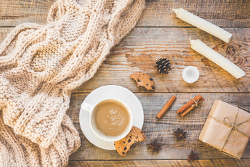 Christmas muffler with cup of cocoa wooden background top view