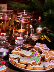 Christmas cookies in the foreground. Christmas still life with hot drinks in glasses and candles.