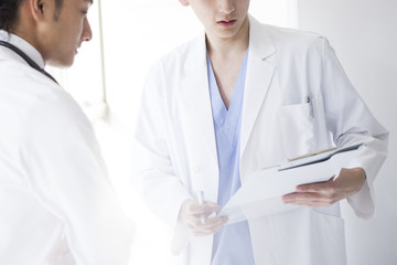 Male doctors are talking while watching a medical record