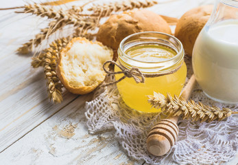 Fresh buns, milk, wheat spikelets and honey