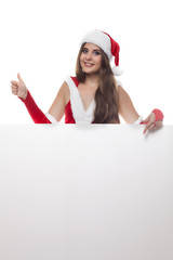 Beauty woman in red christmas dress and hat with an empty billbo