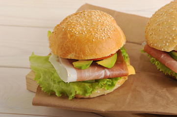 Burger with bacon, avocado, cheese, tomatoes and lettuce